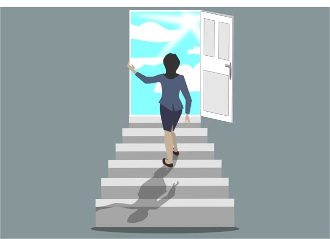 Woman walks up stairs toward a door opening to blue skies