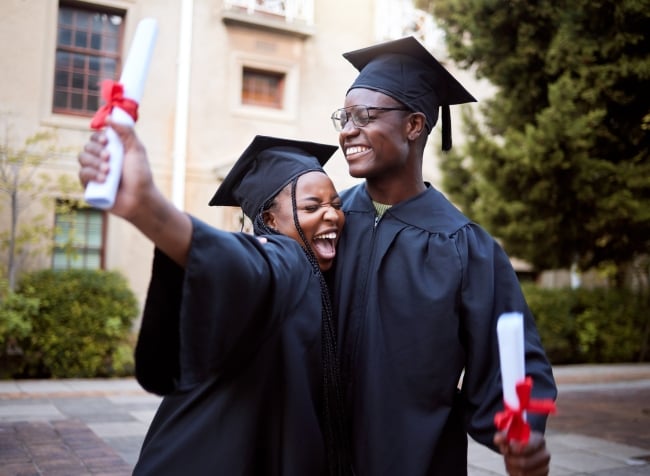 Two Black students celebrate their graduation