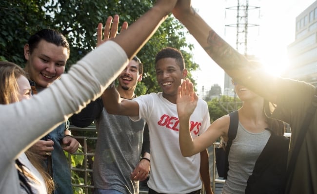 A group of friends hanging out, giving high fives