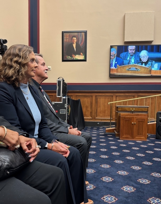 Man and woman sitting in a legislative committee hearing