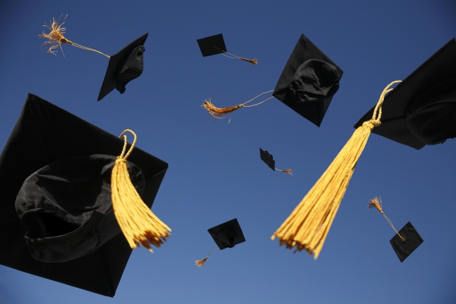 Graduation caps in the air