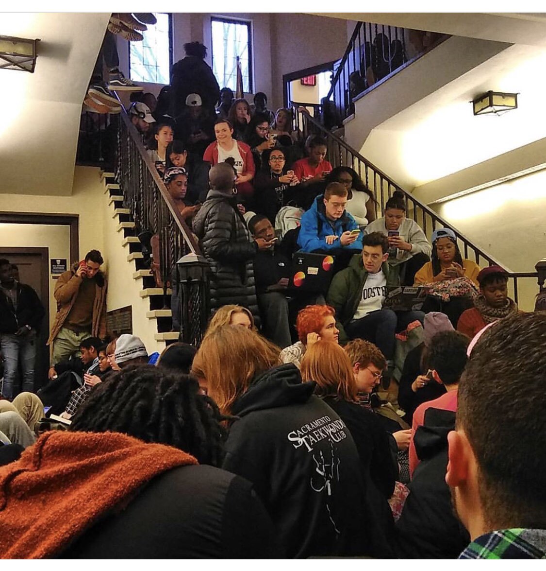 Image of students crowding a staircase and hallway.