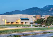 The Centennial Campus at Pikes Peak State College, a series of white buildings set against a backdrop of the mountains.